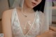 A woman wearing a white dress and a veil.