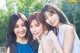 A group of three young women posing for a picture.