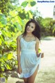 A woman in a white dress posing for a picture.